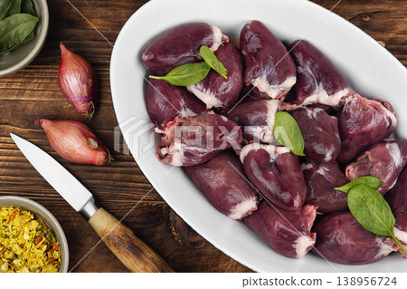 Raw turkey hearts with onion and herbs in baking dish Raw turkey hearts with onion and herbs in baking dish 138956724