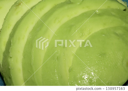 Sliced avocado green vegetable chopped in a line 138957163