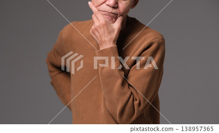 A troubled senior man's hands 138957365