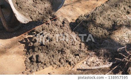 Wet Mortar Pile On Construction Ground With Shovel Marks, Coarse Texture And Moisture Visible, Ready For Transfer To Trowel Or Wheelbarrow, Warm Sunlight And Rough Site Surface Wet Mortar Pile On Construction Ground With Shovel Marks, Coarse Texture And Moisture Visible, Ready For Transfer To Trowel Or Wheelbarrow, Warm Sunlight And Rough Site Surface 138957595