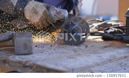 Emergency Repair Action. Field Technician Swiftly Repairing Flange Pipe Damage. Emergency Technician Focused On Repairing Damaged Flange Pipe With Sparks And Protective Equipment 138957631