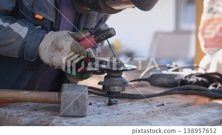 Gloved Hands Operating Angle Grinder On Steel, Closeup Capture Of Rotating Disc And Sparks, Dusty Bench Environment, Tactile Texture And Focused Manual Labor With Protective Clothing Gloved Hands Operating Angle Grinder On Steel, Closeup Capture Of Rotating Disc And Sparks, Dusty Bench Environment, Tactile Texture And Focused Manual Labor With Protective Clothing 138957652