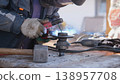Angle Grinder Producing Bright Sparks While Cutting Steel, Dynamic Motion Captured On Workbench, Hands Controlling Tool, Gritty Workshop Light And Tactile Industrial Texture Conveying Steady 138957708