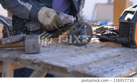 Closeup Hands Cutting Metal With Angle Grinder, Protective Gloves Sending Sparks Across Wooden Workbench Circular Disc Shaving Steel, Power Tool Vibration, Gritty Workshop Atmosphere, Closeup Hands Cutting Metal With Angle Grinder, Protective Gloves Sending Sparks Across Wooden Workbench Circular Disc Shaving Steel, Power Tool Vibration, Gritty Workshop Atmosphere, 138957710