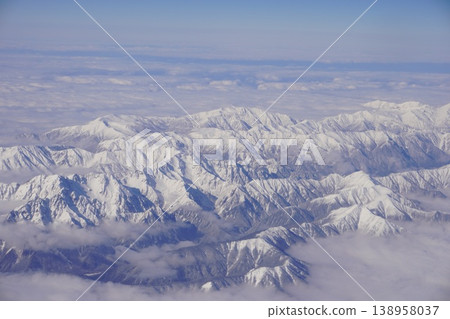 Aerial photograph of the snow-covered mountain range of the Northern Alps in winter, taken from an airplane. Aerial photograph of the snow-covered mountain range of the Northern Alps in winter, taken from an airplane. 138958037