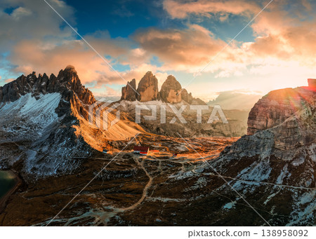 Alpine landscape of sunset over Tre Cime mountain peak and mountain hut during autumn in Dolomites, Italy Alpine landscape of sunset over Tre Cime mountain peak and mountain hut during autumn in Dolomites, Italy 138958092