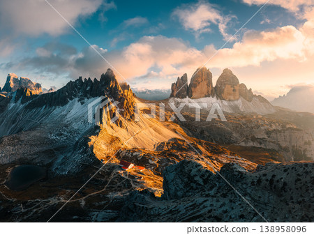 Alpine landscape of sunset over Tre Cime mountain peak and mountain hut during autumn in Dolomites, Italy Alpine landscape of sunset over Tre Cime mountain peak and mountain hut during autumn in Dolomites, Italy 138958096