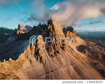 Alpine landscape of Dolomites peaks shines with rugged mountain terrain in sunset at Tre Cime Alpine landscape of Dolomites peaks shines with rugged mountain terrain in sunset at Tre Cime 138958097