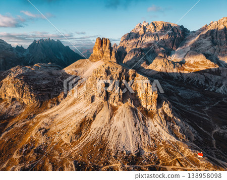 Alpine landscape of Dolomites peaks shines with rugged mountain terrain in sunset at Tre Cime Alpine landscape of Dolomites peaks shines with rugged mountain terrain in sunset at Tre Cime 138958098