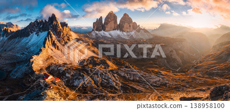 Alpine landscape of sunset over Tre Cime mountain peak and mountain hut during autumn in Dolomites, Italy 138958100