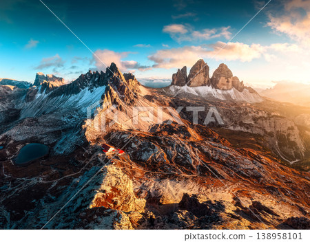 Alpine landscape of sunset over Tre Cime mountain peak and mountain hut during autumn in Dolomites, Italy Alpine landscape of sunset over Tre Cime mountain peak and mountain hut during autumn in Dolomites, Italy 138958101