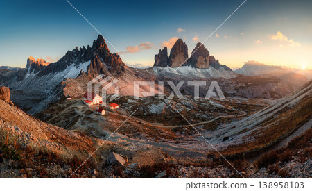 Scenic view of Tre Cime di Lavaredo peaks and rifugio locatelli mountain hut in the sunset at Dolomites, italy Scenic view of Tre Cime di Lavaredo peaks and rifugio locatelli mountain hut in the sunset at Dolomites, italy 138958103
