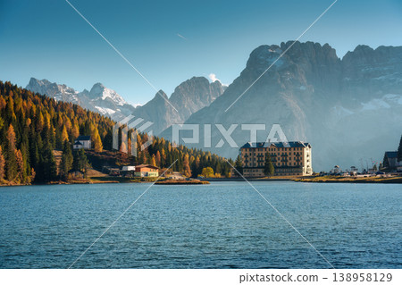 Lake Misurina with autumn larch forest and historic hotel in alpine dolomites mountain Lake Misurina with autumn larch forest and historic hotel in alpine dolomites mountain 138958129