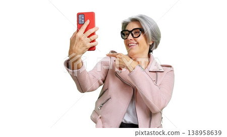 Senior woman taking selfie with smartphone pointing finger 138958639