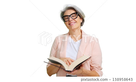 Smiling mature woman reading book wearing glasses Smiling mature woman reading book wearing glasses 138958643