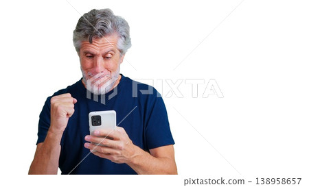 Senior man celebrating good news on smartphone Senior man celebrating good news on smartphone 138958657