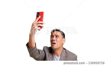 Man experiencing issues while holding red smartphone 138958738