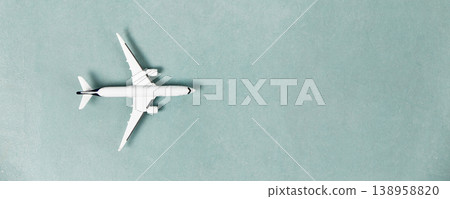Minimalist Flat Lay with Airplane Model on Blue Background 138958820