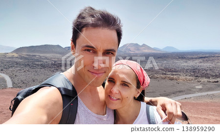 Couple enjoying volcanic landscape vacation self portrait in Timanfaya 138959290
