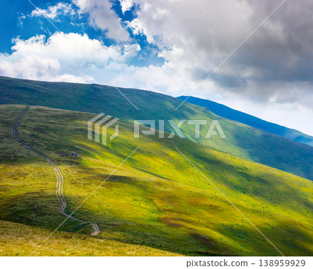 carpathian mountain landscape of ukraine in summer. beautiful travel background with rolling hills. lush green grassy hillside in dappled light. transcarpathia vacation season. narrow telephoto view carpathian mountain landscape of ukraine in summer. beautiful travel background with rolling hills. lush green grassy hillside in dappled light. transcarpathia vacation season. narrow telephoto view 138959929
