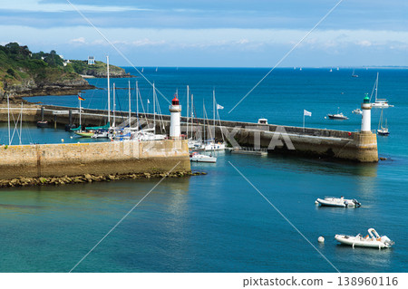 Summer Harbor With Twin Lighthouses, Marina and Sailboats Docked Along a Stone Breakwater Summer Harbor With Twin Lighthouses, Marina and Sailboats Docked Along a Stone Breakwater 138960116