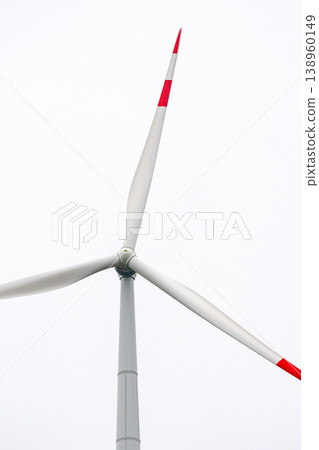 wind turbines in field rotate their blades to generate energy. windmill on spacious green field. wind turbines in field rotate their blades to generate energy. windmill on spacious green field. 138960149