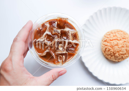 iced coffee , iced latte coffee or iced cappuccino coffee and choux cream or cream puff or eclair iced coffee , iced latte coffee or iced cappuccino coffee and choux cream or cream puff or eclair 138960634