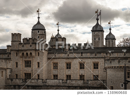 Beneath a brooding, silver-edged sky, the Tower of London stands as a formidable sentinel of history. Its rugged limestone walls, weathered by centuries of salt and secrets, rise with a heavy, ancient Beneath a brooding, silver-edged sky, the Tower of London stands as a formidable sentinel of history. Its rugged limestone walls, weathered by centuries of salt and secrets, rise with a heavy, ancient 138960688