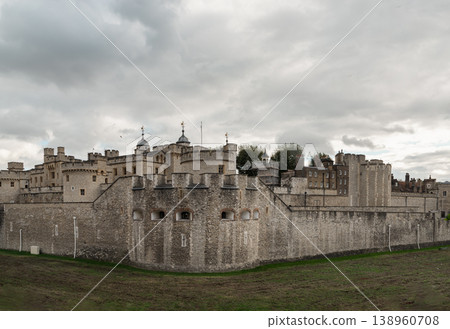 The Tower of London stands as a formidable stone sentinel beneath a heavy, melancholic English sky. Its massive curtain walls of weathered limestone and flint breathe a hushed solemnity, thick with a The Tower of London stands as a formidable stone sentinel beneath a heavy, melancholic English sky. Its massive curtain walls of weathered limestone and flint breathe a hushed solemnity, thick with a 138960708