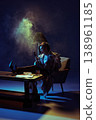 Angry woman smoking cigar and shouting into phone in dramatic studio lighting. 138961185
