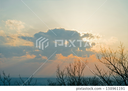 Sunset shining through from behind the clouds Sunset shining through from behind the clouds 138961191