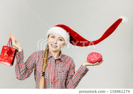 Christmas woman holding shopping bag and brain Christmas woman holding shopping bag and brain 138961274