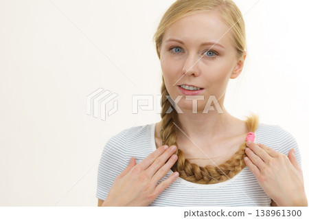 Blonde girl with long braid hair Blonde girl with long braid hair 138961300
