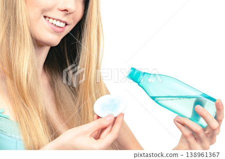 Woman cleaning her face skin with cotton pad Woman cleaning her face skin with cotton pad 138961367