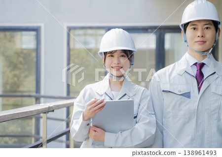 Portrait of a young man and woman in work clothes 138961493