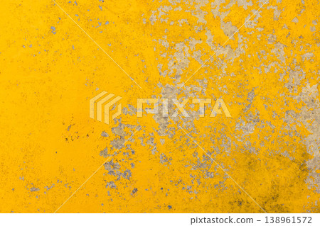 Textured concrete surface with peeling yellow paint outdoors Textured concrete surface with peeling yellow paint outdoors 138961572