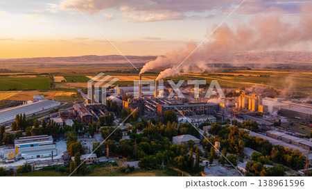 Industrial cement plant with smokestacks and agricultural fields at sunset Industrial cement plant with smokestacks and agricultural fields at sunset 138961596