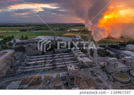 Aerial view of Industrial cement plant with smokestacks and agricultural fields at sunset 138961597