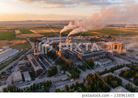 aerial view of Industrial cement plant with smokestacks and agricultural fields at sunset aerial view of Industrial cement plant with smokestacks and agricultural fields at sunset 138961605