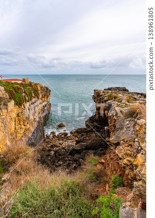 Rocky coastal cliffs and ocean inlet in Cascais Portugal Rocky coastal cliffs and ocean inlet in Cascais Portugal 138961805
