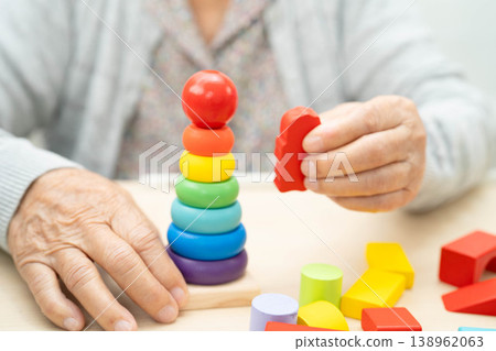 Asian elderly woman playing game. Asian elderly woman playing game. 138962063