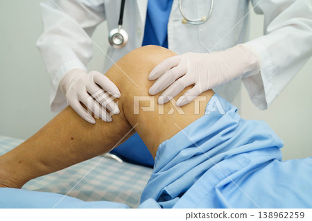 Doctor checking Asian elderly woman patient with scar knee replacement surgery in hospital. Doctor checking Asian elderly woman patient with scar knee replacement surgery in hospital. 138962259