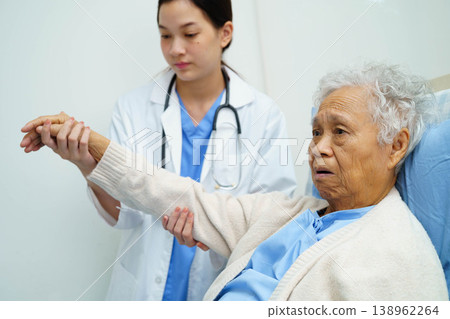 Asian doctor checking and treat elderly woman patient health in hospital. Asian doctor checking and treat elderly woman patient health in hospital. 138962264