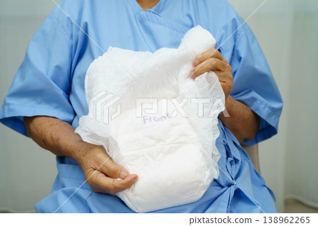 Asian senior woman patient wearing adult incontinence diaper pad in hospital. Asian senior woman patient wearing adult incontinence diaper pad in hospital. 138962265