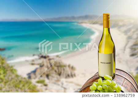 White wine bottle with grapes by sea beach White wine bottle with grapes by sea beach 138962759
