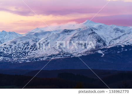 A view of the snow-covered Tokachi-dake mountain range bathed in the morning light, seen from Miyama Pass in Hokkaido. A view of the snow-covered Tokachi-dake mountain range bathed in the morning light, seen from Miyama Pass in Hokkaido. 138962770