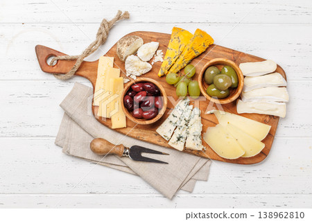 Cheese board with assorted cheeses and olives Cheese board with assorted cheeses and olives 138962810