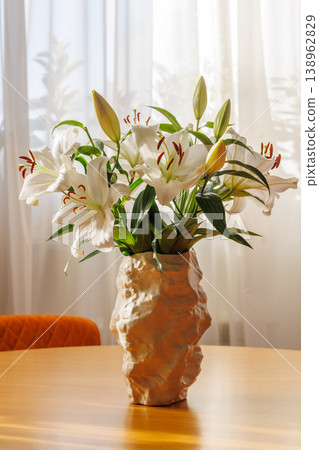 White Lily Flowers in Vase on Wooden Table 138962829