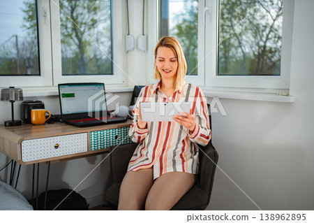 Woman working from home using digital tablet technology 138962895