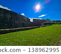Scenic view of old stone fortifications and a hiking trail on a moody overcast day. 138962995